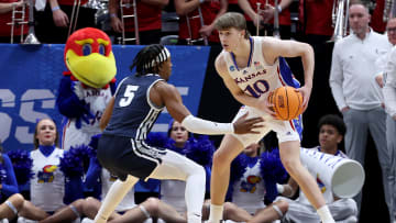 Mar 21, 2024; Salt Lake City, UT, USA; Kansas Jayhawks guard Johnny Furphy (10) looks to pass against Samford Bulldogs guard A.J. Staton-McCray (5) during the second half in the first round of the 2024 NCAA Tournament at Vivint Smart Home Arena-Delta Center. Mandatory Credit: Rob Gray-USA TODAY Sports