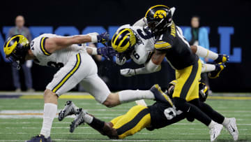 Dec 2, 2023; Indianapolis, IN, USA; Michigan Wolverines wide receiver Cornelius Johnson (6) is tackled by Iowa Hawkeyes defensive back Xavier Nwankpa (1) during the second half of the Big Ten Championship game at Lucas Oil Stadium. Mandatory Credit: Trevor Ruszkowski-USA TODAY Sports