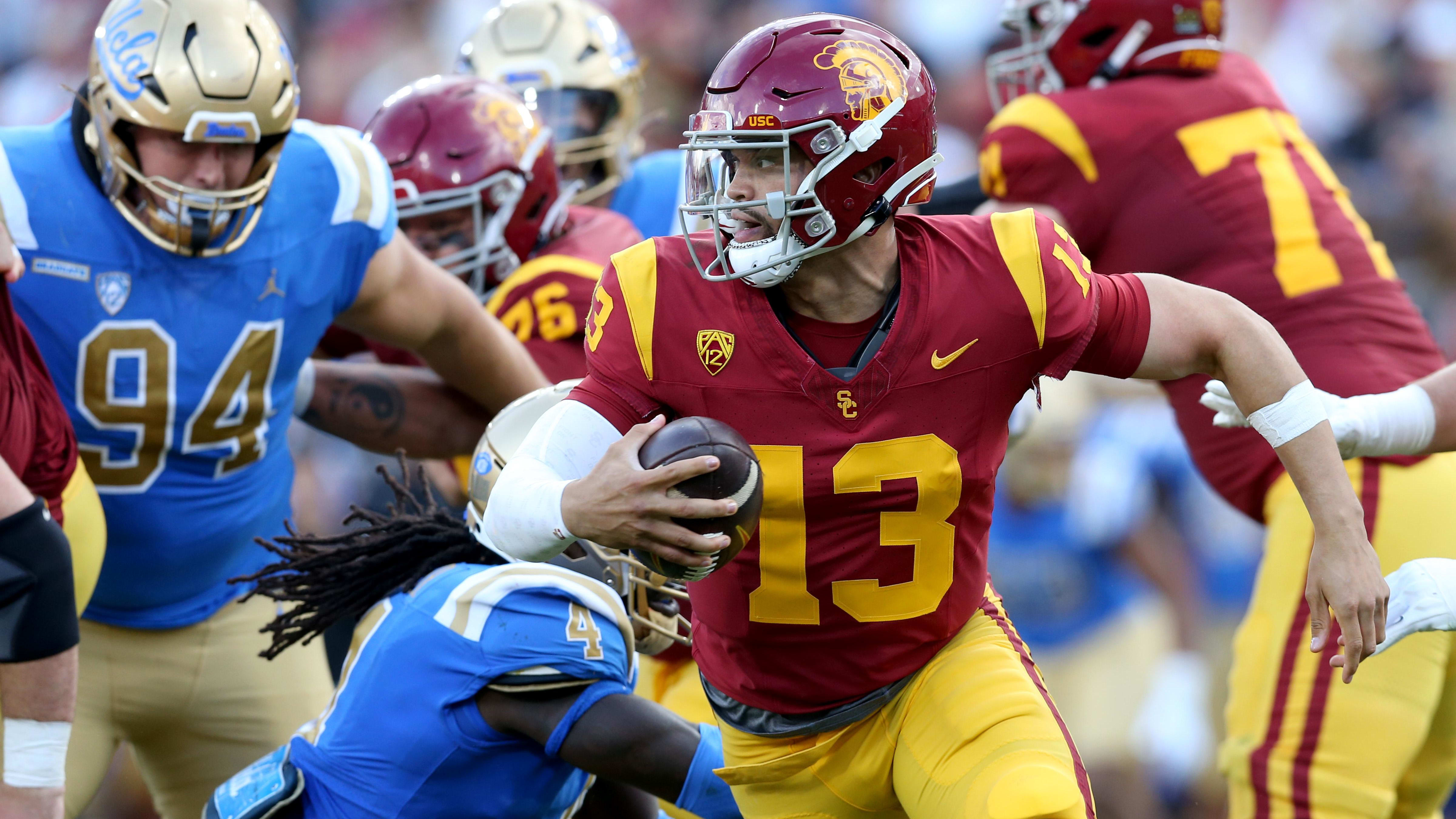 Caleb Williams scrambles free of the rush against UCLA.