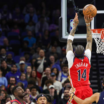 Mar 21, 2024; Orlando, Florida, USA; New Orleans Pelicans forward Brandon Ingram (14) shoots the ball against Orlando Magic forward Franz Wagner (22) during the first quarter at KIA Center