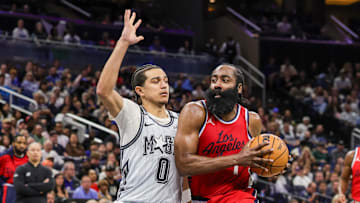 Mar 31, 2025; Orlando, Florida, USA; LA Clippers guard James Harden (1) drives against Orlando Magic guard Anthony Black (0) during the second half at Kia Center. Mandatory Credit: Mike Watters-Imagn Images