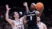 Samford Bulldogs guard Josh Holloway drives against Kansas Jayhawks guard Nicolas Timberlake.