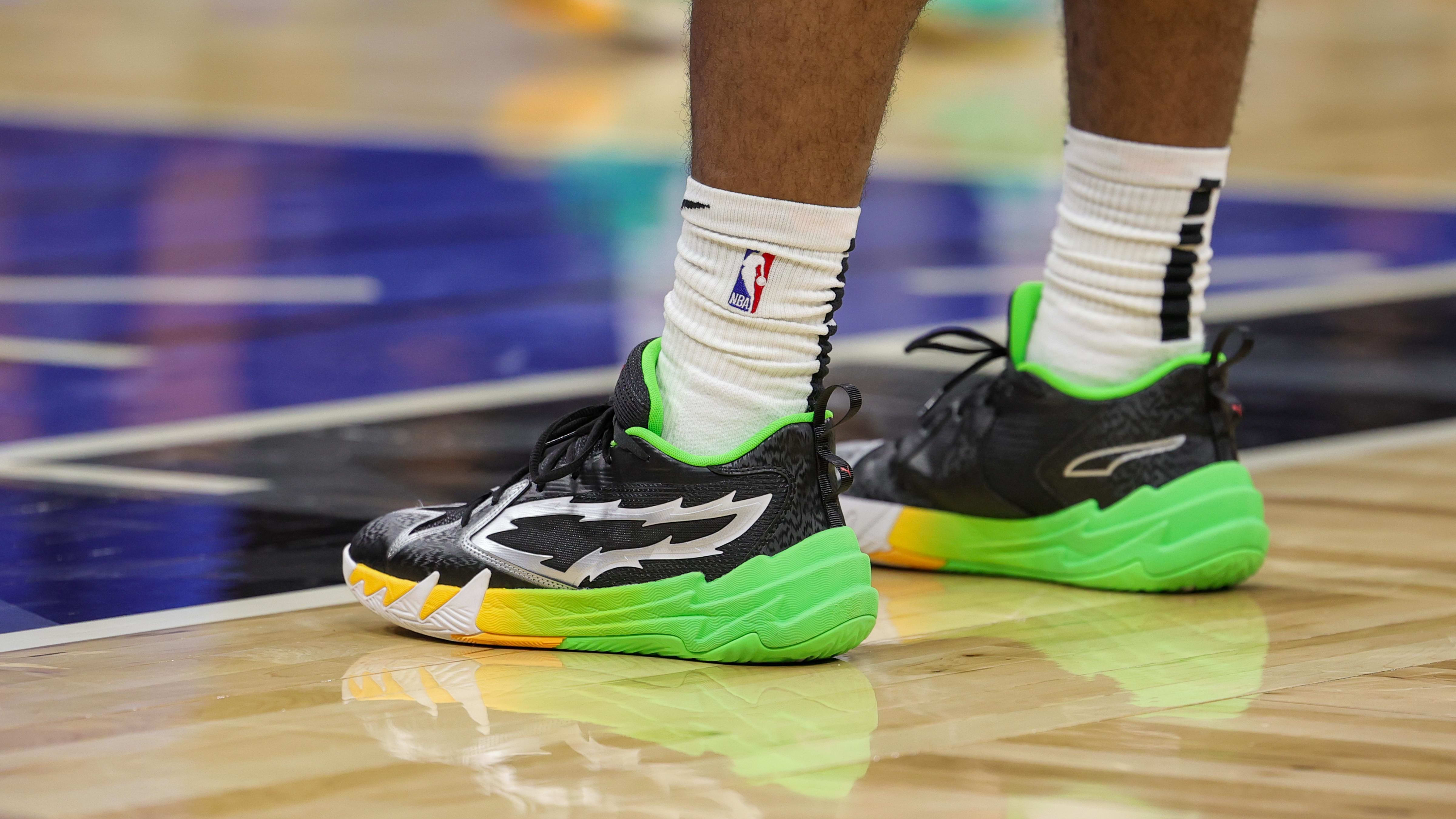 Portland Trail Blazers guard Scoot Henderson's black and green PUMA sneakers.