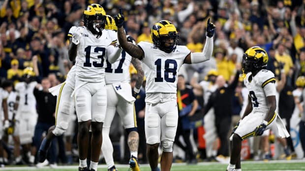 Michigan Wolverines defensive back Ja'Den McBurrows and defensive back DJ Waller Jr. celebrate after a turnover.