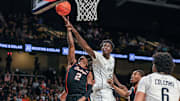 Mar 5, 2025; Orlando, Florida, USA; UCF Knights center Moustapha Thiam (52) blocks a shot by Oklahoma State Cowboys guard Arturo Dean (2) during the first half at Addition Financial Arena. Mandatory Credit: Mike Watters-Imagn Images