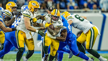 Green Bay Packers running back Josh Jacobs breaks through the Detroit Lions defensive line before being tackled during the Thursday Night Football game at Ford Field in Detroit on Thursday, Dec. 5, 2024. Jacobs scored three rushing touchdowns in the Lions' 34-31 win.