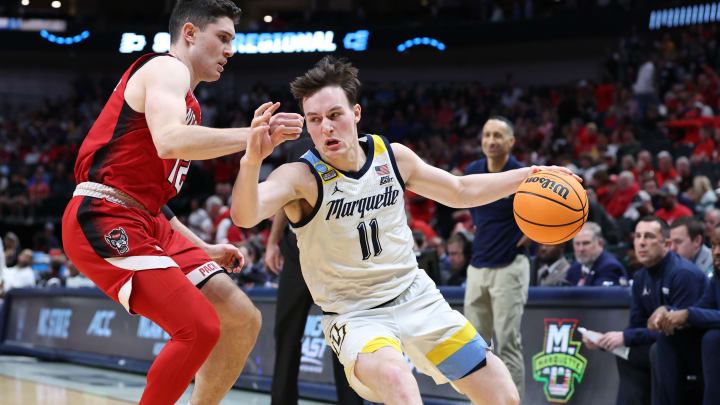 Mar 29, 2024; Dallas, TX, USA; Marquette Golden Eagles guard Tyler Kolek (11) dribble against North Carolina State Wolfpack guard Michael O'Connell (12) during the second half in the semifinals of the South Regional of the 2024 NCAA Tournament at American Airlines Center. Mandatory Credit: Tim Heitman-USA TODAY Sports 
