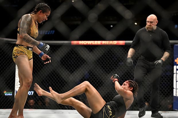 Julianna Peña fights Amanda Nunes in a women's bantamweight title bout during UFC 277 at the American Airlines Center. 