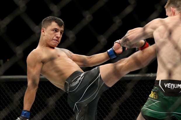 Jamie Mullarkey (red gloves) fights Francisco Prado (blue gloves) during UFC 284 at RAC Arena. 