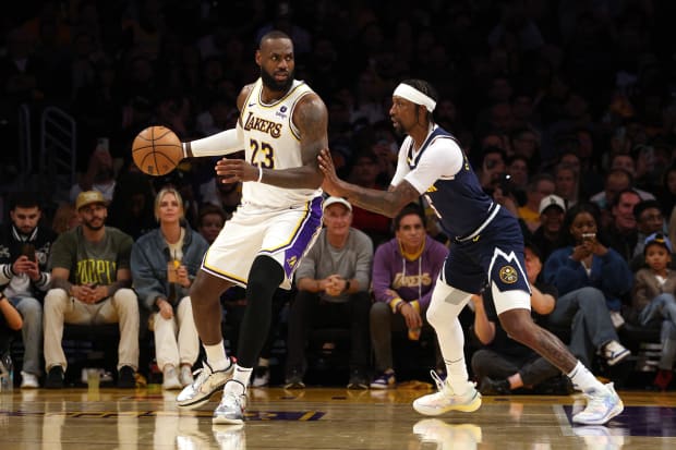  Los Angeles Lakers forward LeBron James (23) dribbles against Denver Nuggets guard Kentavious Caldwell-Pope (5).