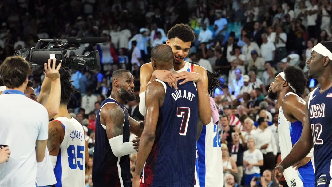 Aug 10, 2024; Paris, France; United States guard Kevin Durant (7) embraces France power forward Victor Wembanyama (32) after the men's basketball gold medal game during the Paris 2024 Olympic Summer Games at Accor Arena. Mandatory Credit: Rob Schumacher-USA TODAY Sports