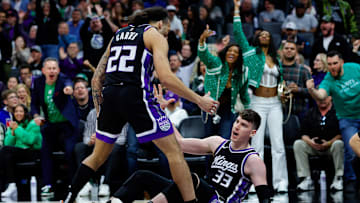 Mar 17, 2025; Sacramento, California, USA; Sacramento Kings forward Jake LaRavia (33) is picked up by guard Devin Carter (22) after a basket during the second quarter at Golden 1 Center. Mandatory Credit: Sergio Estrada-Imagn Images