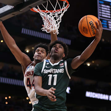 Mar 30, 2025; Atlanta, GA, USA; Michigan State Spartans guard Jase Richardson (11) shoots against Auburn Tigers center Dylan Cardwell (44) during the second half in the South Regional final of the 2025 NCAA tournament at State Farm Arena. Mandatory Credit: Brett Davis-Imagn Images