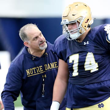 Notre Dame offensive line coach Joe Rudolph speaks with redshirt freshman guard Billy Schrauth (74) during drills Saturday, March 25, 2023, at Notre Dame spring football practice in South Bend.

Nd Fb Practice 03252023