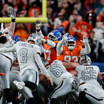 Nov 6, 2025; Denver, Colorado, USA; Las Vegas Raiders place kicker Daniel Carlson (8) misses a field goal as Denver Broncos defensive tackle D.J. Jones (93) and wide receiver A.T. Perry (87) defend in the fourth quarter at Empower Field at Mile High. Mandatory Credit: Isaiah J. Downing-Imagn Images