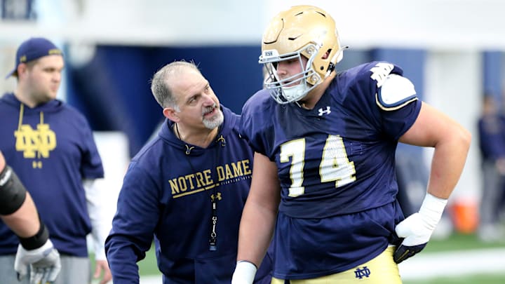 Notre Dame offensive line coach Joe Rudolph speaks with redshirt freshman guard Billy Schrauth (74) during drills Saturday, March 25, 2023, at Notre Dame spring football practice in South Bend.

Nd Fb Practice 03252023