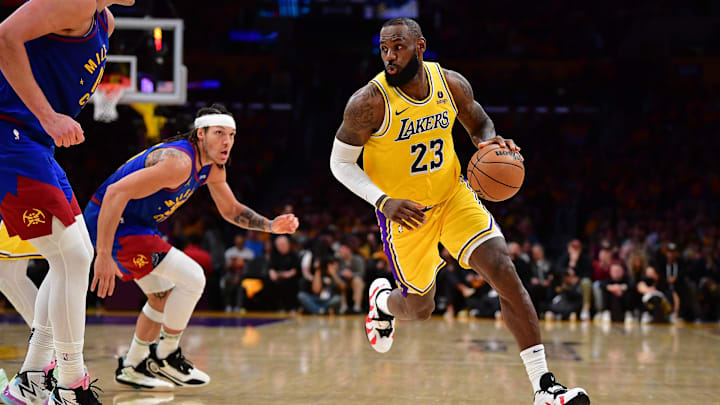 Apr 25, 2024; Los Angeles, California, USA; Los Angeles Lakers forward LeBron James (23) moves the ball against Denver Nuggets center Nikola Jokic (15) and forward Aaron Gordon (50) during the second half in game three of the first round for the 2024 NBA playoffs at Crypto.com Arena. Mandatory Credit: Gary A. Vasquez-Imagn Images