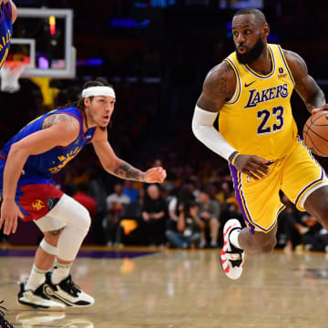 Apr 25, 2024; Los Angeles, California, USA; Los Angeles Lakers forward LeBron James (23) moves the ball against Denver Nuggets center Nikola Jokic (15) and forward Aaron Gordon (50) during the second half in game three of the first round for the 2024 NBA playoffs at Crypto.com Arena. Mandatory Credit: Gary A. Vasquez-USA TODAY Sports