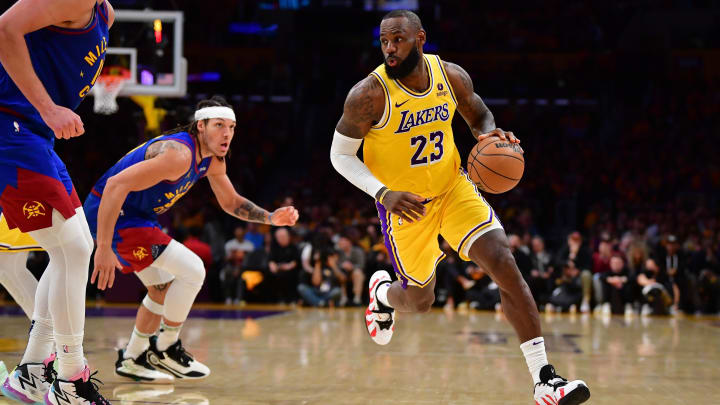 Apr 25, 2024; Los Angeles, California, USA; Los Angeles Lakers forward LeBron James (23) moves the ball against Denver Nuggets center Nikola Jokic (15) and forward Aaron Gordon (50) during the second half in game three of the first round for the 2024 NBA playoffs at Crypto.com Arena. Mandatory Credit: Gary A. Vasquez-USA TODAY Sports