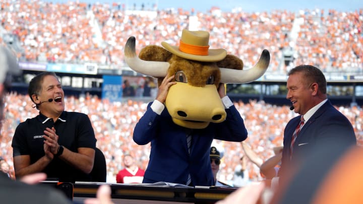 Lee Corso picks Texas to win as Mark Cuban, left, and Kirk Herbstreit laugh during ESPN's College GameDay show before the Red River Showdown college football game between the University of Oklahoma Sooners (OU) and the University of Texas (UT) Longhorns at the Cotton Bowl in Dallas, Saturday, Oct. 9, 2021.  Oklahoma won 55-48.