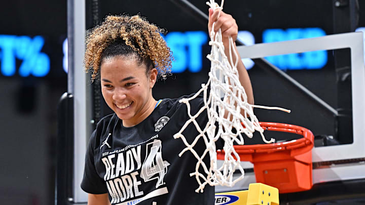 Mar 30, 2025; Spokane, WA, USA; UCLA Bruins guard Kiki Rice (1) holds the net after an Elite 8 NCAA Tournament basketball game against the LSU Lady Tigers at Spokane Arena. Mandatory Credit: James Snook-Imagn Images
