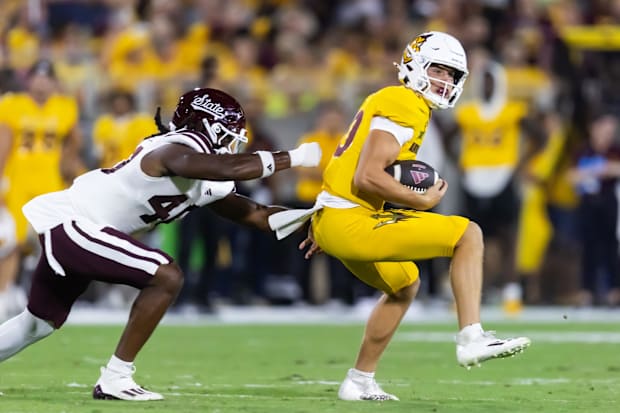 Arizona State Sun Devils quarterback Sam Leavitt spins away from Mississippi State Bulldogs linebacker Nic Mitchell.