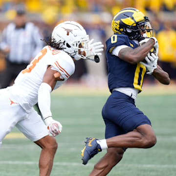 Michigan wide receiver Semaj Morgan (0) makes a catch against Texas defensive back Jaylon Guilbeau (3) during the first half at Michigan Stadium in Ann Arbor on Saturday, September 7, 2024.