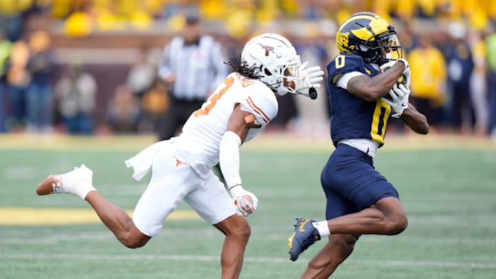 Michigan wide receiver Semaj Morgan (0) makes a catch against Texas defensive back Jaylon Guilbeau (3) during the first half at Michigan Stadium in Ann Arbor on Saturday, September 7, 2024.