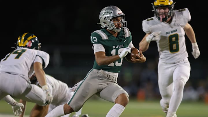 De La Salle QB Toa Faavae jukes a couple defenders on his way to a 12-yard scamper in Friday's 42-14 win over San Ramon Valley.