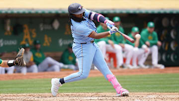 Jun 8, 2024; Oakland, California, USA; Toronto Blue Jays first baseman Vladimir Guerrero Jr. (27) hits a double against the Oakland Athletics in the fifth inning at Oakland-Alameda County Coliseum. Mandatory Credit: Cary Edmondson-USA TODAY Sports