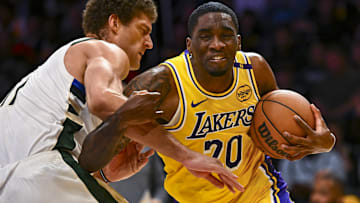 Los Angeles Lakers guard Shake Milton (20) charges the basket against Milwaukee Bucks center Brook Lopez (11) during the second half at Crypto.com Arena. 