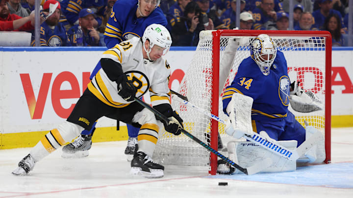 Apr 28, 2026; Buffalo, New York, USA; Buffalo Sabres defenseman Logan Stanley (64) defends as Boston Bruins center Michael Eyssimont (81) takes a shot on Buffalo Sabres goaltender Alex Lyon (34) during the third period in game five of the first round of the 2026 Stanley Cup Playoffs at KeyBank Center. Mandatory Credit: Timothy T. Ludwig-Imagn Images