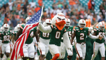 Sep 21, 2019; Miami Gardens, FL, USA; Miami Hurricanes mascot Sebastian the Ibis carries a U.S. flag as the Miami Hurricanes football team take the field to face the Central Michigan Chippewas at Hard Rock Stadium. Mandatory Credit: Sam Navarro-USA TODAY Sports