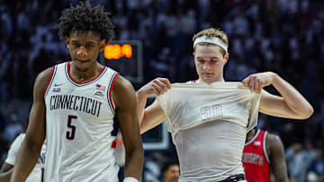 Feb 7, 2025; Storrs, Connecticut, USA; UConn Huskies forward Liam McNeeley (30) and center Tarris Reed Jr. (5) on the court after a defeat by the St. John's Red Storm at Harry A. Gampel Pavilion. Mandatory Credit: David Butler II-Imagn Images