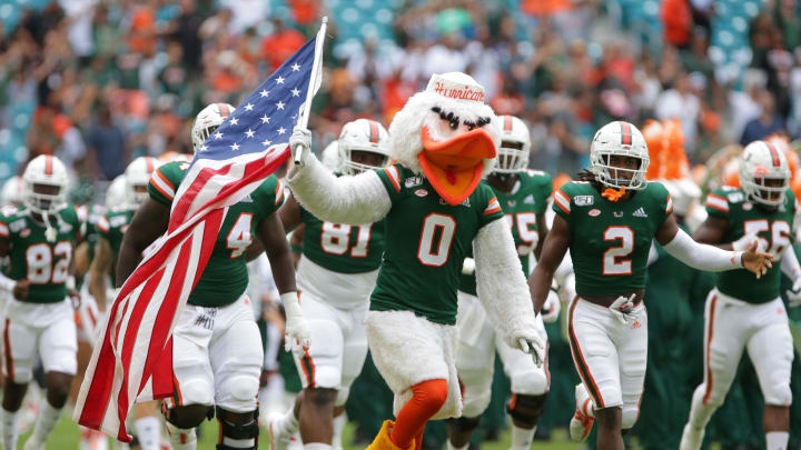 Miami Hurricanes mascot Sebastian the Ibis leads the team onto the field