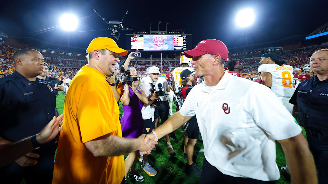Sep 21, 2024; Norman, Oklahoma, USA;  Tennessee Volunteers head coach Josh Heupel (left) shakes hands with Oklahoma Sooners head coach Brent Venables (right) after the game at Gaylord Family-Oklahoma Memorial Stadium. Mandatory Credit: Kevin Jairaj-Imagn Images
