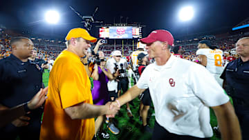 Sep 21, 2024; Norman, Oklahoma, USA;  Tennessee Volunteers head coach Josh Heupel (left) shakes hands with Oklahoma Sooners head coach Brent Venables (right) after the game at Gaylord Family-Oklahoma Memorial Stadium. Mandatory Credit: Kevin Jairaj-Imagn Images