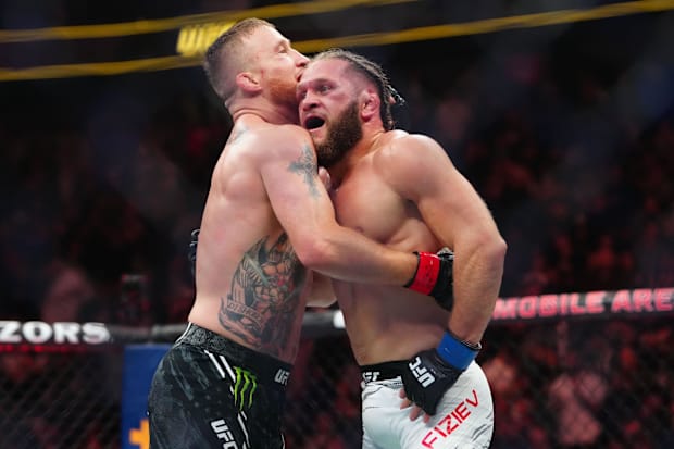 Justin Gaethje (red gloves) reacts after fighting Rafael Fiziev (blue gloves) during UFC 313 at T-Mobile Arena.