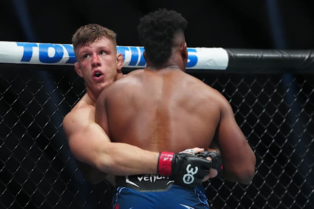 Jimmy Crute (red gloves) fights Alonzo Menifield (blue gloves) during UFC 290 at T-Mobile Arena. 