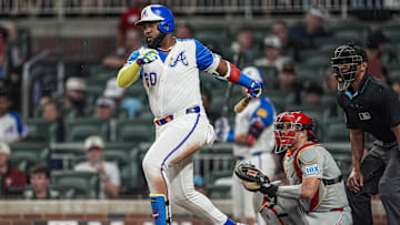 Jun 28, 2025; Cumberland, Georgia, USA; Atlanta Braves designated hitter Marcell Ozuna (20) singles against the Philadelphia Phillies during the seventh inning at Truist Park. Mandatory Credit: Dale Zanine-Imagn Images