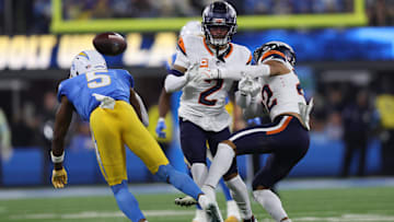 December 19, 2024, Inglewood, California, USA: Denver Broncos safety BRANDON JONES (22) and cornerback PATRICK SURTAIN II (2) challenge a catch attempt from Los Angeles Chargers wide receiver JOSH PALMER (5) during a NFL, American Football Herren, USA football game between the Denver Broncos and the Los Angeles Chargers at SoFi Stadium in Inglewood, California.