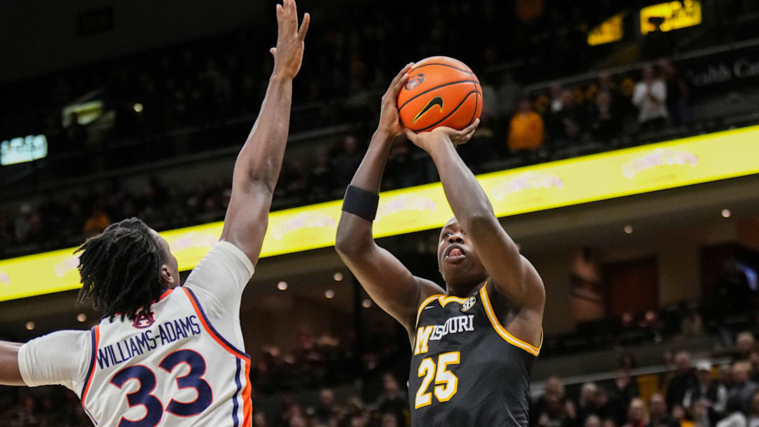 Jan 14, 2026; Columbia, Missouri, USA; Missouri Tigers guard Mark Mitchell (25) shoots as Auburn Tigers forward Sebastian Williams-Adams (33) defends during the first half of the game at Mizzou Arena. Mandatory Credit: Denny Medley-Imagn Images
