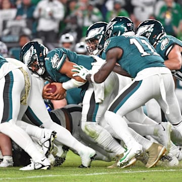 Nov 5, 2023; Philadelphia, Pennsylvania, USA; Philadelphia Eagles quarterback Jalen Hurts (1) picks up yardage a first down with a push from wide receiver A.J. Brown (11) and tight end Dallas Goedert (88) against the Dallas Cowboys at Lincoln Financial Field. Mandatory Credit: Eric Hartline-Imagn Images