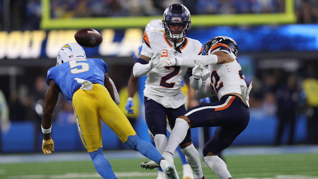 December 19, 2024, Inglewood, California, USA: Denver Broncos safety BRANDON JONES (22) and cornerback PATRICK SURTAIN II (2) challenge a catch attempt from Los Angeles Chargers wide receiver JOSH PALMER (5) during a NFL, American Football Herren, USA football game between the Denver Broncos and the Los Angeles Chargers at SoFi Stadium in Inglewood, California. December 19, 2024, Inglewood, California, USA: Denver Broncos safety BRANDON JONES (22) and cornerback PATRICK SURTAIN II (2) challenge a catch attempt from Los Angeles Chargers wide receiver JOSH PALMER (5) during a NFL, American Football Herren, USA football game between the Denver Broncos and the Los Angeles Chargers at SoFi Stadium in Inglewood, California.