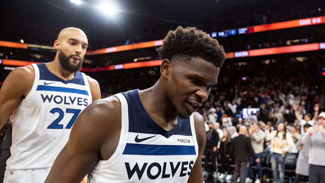 Nov 21, 2025; Phoenix, Arizona, USA; Minnesota Timberwolves guard Anthony Edwards (5) and center Rudy Gobert (27) react as they walk off the court after losing to the Phoenix Suns in the second half of an NBA Cup game at Mortgage Matchup Center. Mandatory Credit: Mark J. Rebilas-Imagn Images
