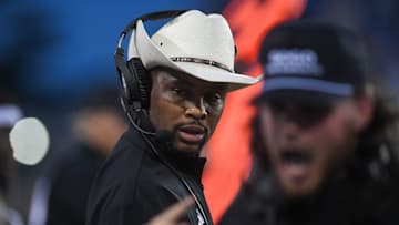 Sacramento State Hornets head coach Brennan Marion listens to one of the assistant coaches yell at players on Saturday, Aug. 30, 2025, at Dana J. Dykhouse Stadium in Brookings, South Dakota.