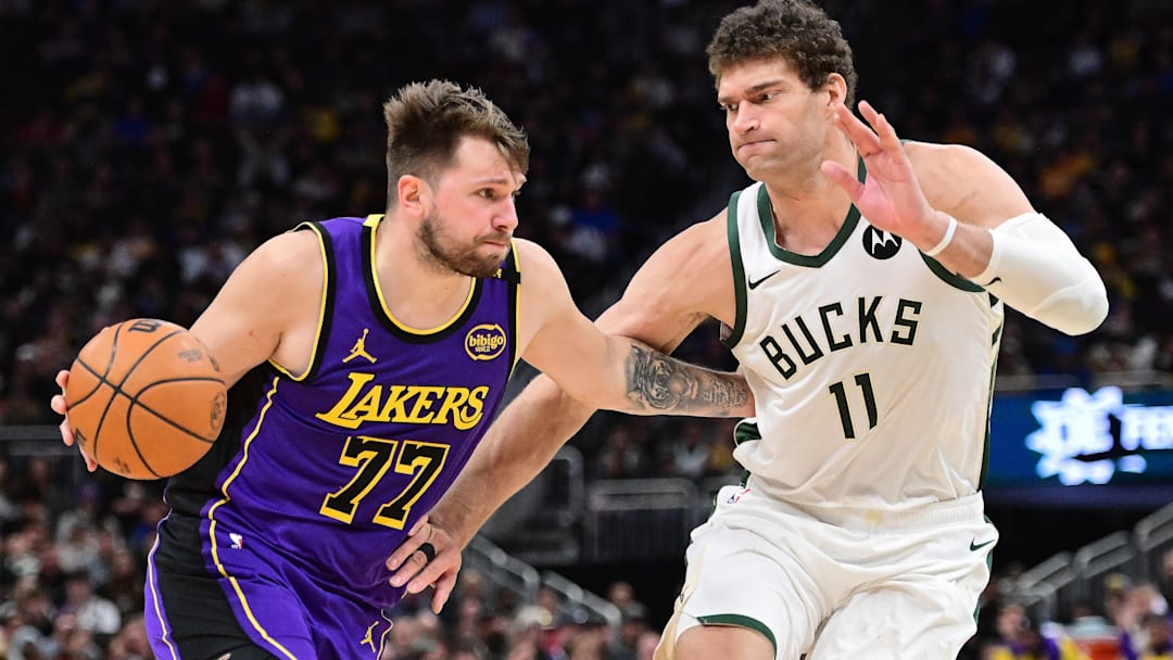 Los Angeles Lakers guard Luka Doncic (77) drives to the basket against Milwaukee Bucks center Brook Lopez (11) in the fourth quarter at Fiserv Forum.
