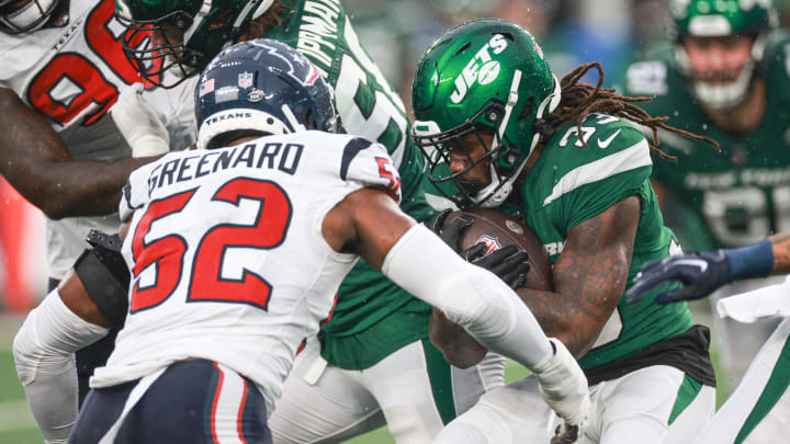 Dec 10, 2023; East Rutherford, New Jersey, USA; New York Jets running back Dalvin Cook (33) is tackled by Houston Texans defensive end Jonathan Greenard (52) during the first half at MetLife Stadium. 