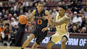 Mar 9, 2024; Tallahassee, Florida, USA; Miami Hurricanes guard Matthew Cleveland (0) drives the ball to the net against Florida State Seminoles guard Primo Spears (23) during the first half at Donald L. Tucker Center. 