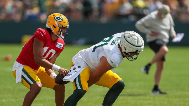 Green Bay Packers quarterback Jordan Love (10) takes a snap from center Josh Myers (71) during the 12th practice of training camp on Tuesday, August 6, 2024, at Ray Nitschke Field in Ashwaubenon, Wis. 
Tork Mason/USA TODAY NETWORK-Wisconsin